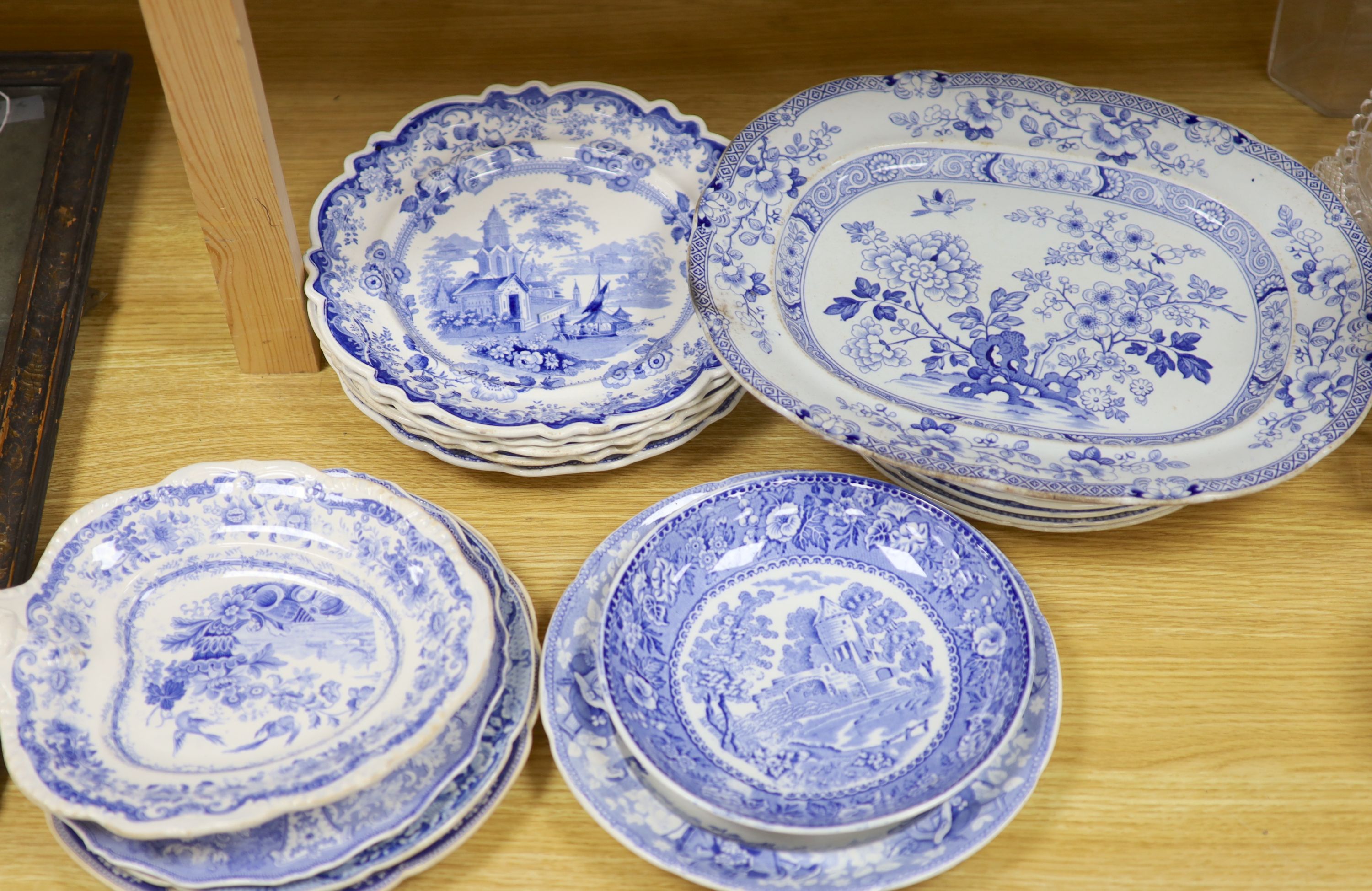 A collection of 19th and 20th century blue and white pottery plates and dishes